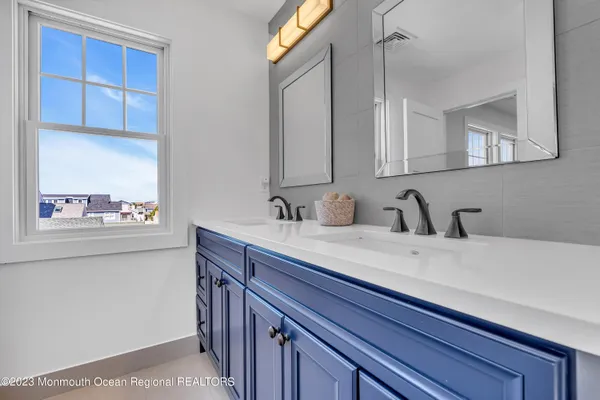 a bathroom with a sink toilet a mirror and shower