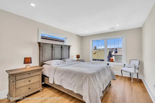 a bedroom with a bed and a view of kitchen