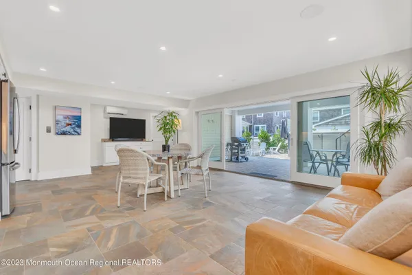 a view of a dining room with furniture and a potted plant