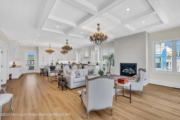 a living room with fireplace furniture and a wooden floor