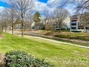 19831 Henderson Road, Unit A Cornelius, NC 28031 - Photo 14 of 15 a backyard of apartments with large trees