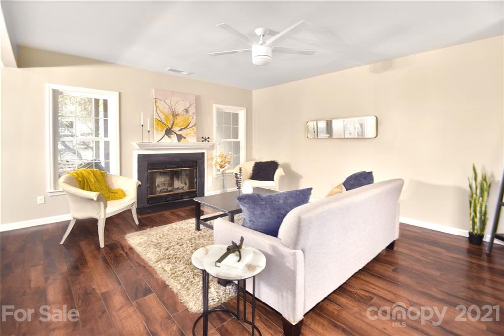 19831 Henderson Road, Unit A Cornelius, NC 28031 - Photo 3 of 15 a living room with furniture a fireplace and a table
