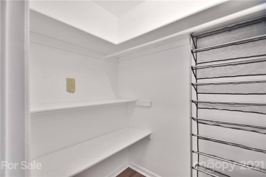 19831 Henderson Road, Unit A Cornelius, NC 28031 - Photo 9 of 15 a view of walk in closet with empty racks