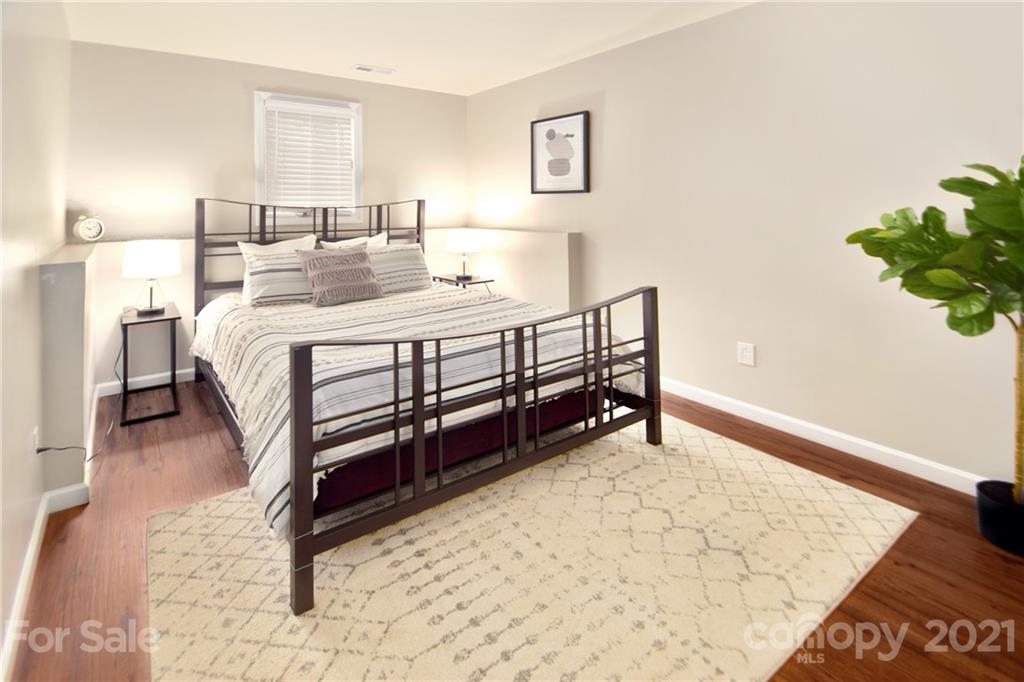 19831 Henderson Road, Unit A Cornelius, NC 28031 - Photo 10 of 15 a bedroom with a bed table and a window