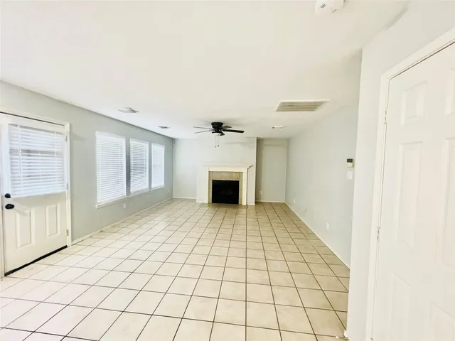 a view of an empty room with a fireplace