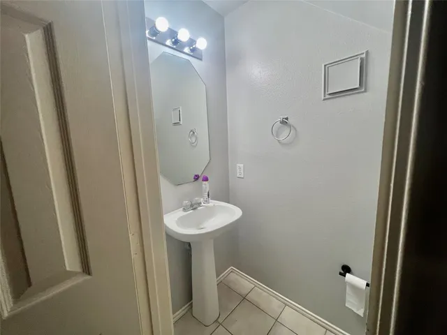 a bathroom with a sink and mirror with toilet