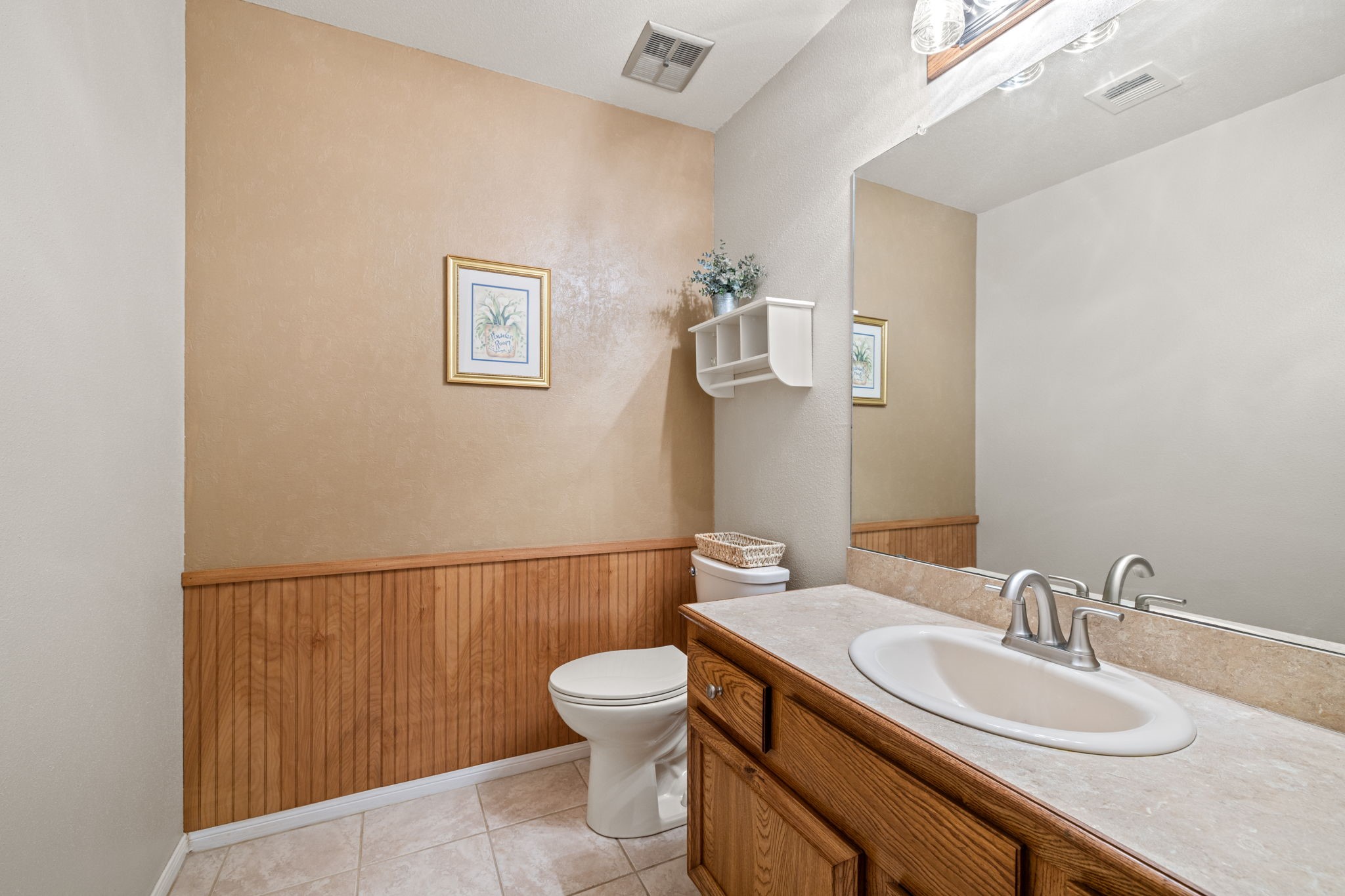 9102 Woodhouse Drive Spring, TX 77379 - Photo 14 of 32 POWDER ROOM - Nice guest bathroom located downstairs. Toilet has been updated with the comfort height toilet. Faucet has been recently replaced.