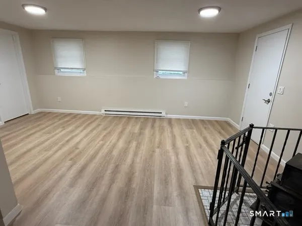 a view of an empty room and wooden floor