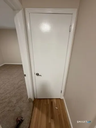 a view of a room with wooden floor