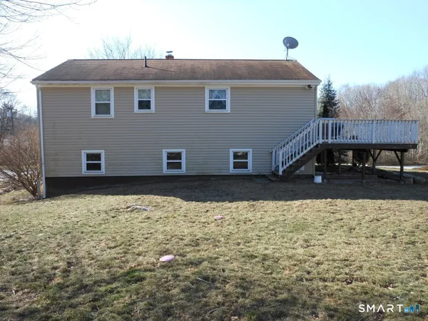 a view of house with backyard
