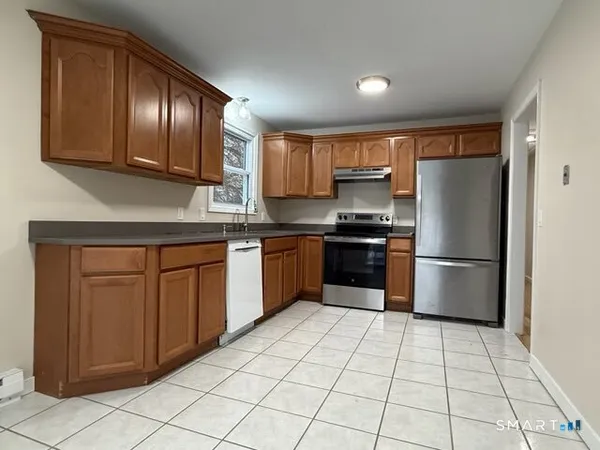 a kitchen with stainless steel appliances granite countertop a refrigerator sink and cabinets