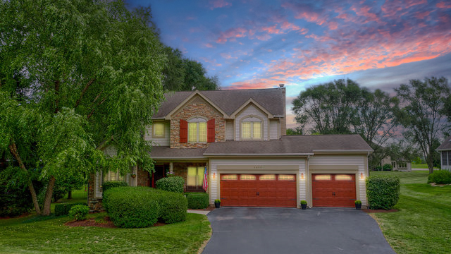 6604 Wildberry Lane Cary, IL 60013 - Photo 3 of 5 a front view of a house with a yard and garage