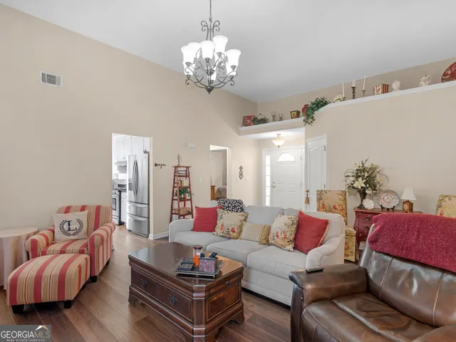 a living room with furniture and a chandelier