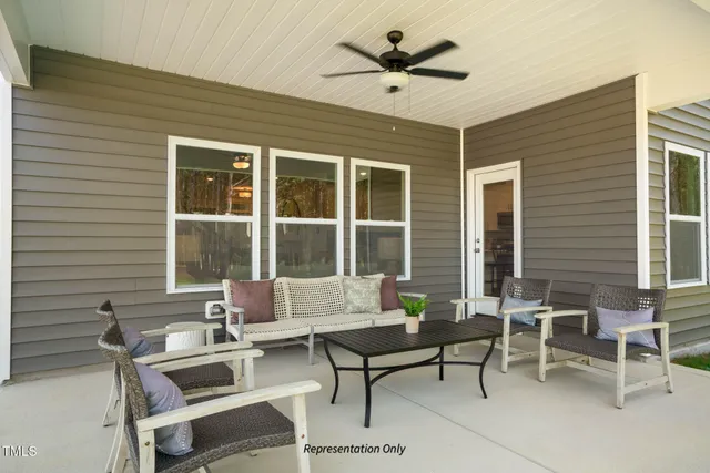 a building outdoor space with patio furniture and garden