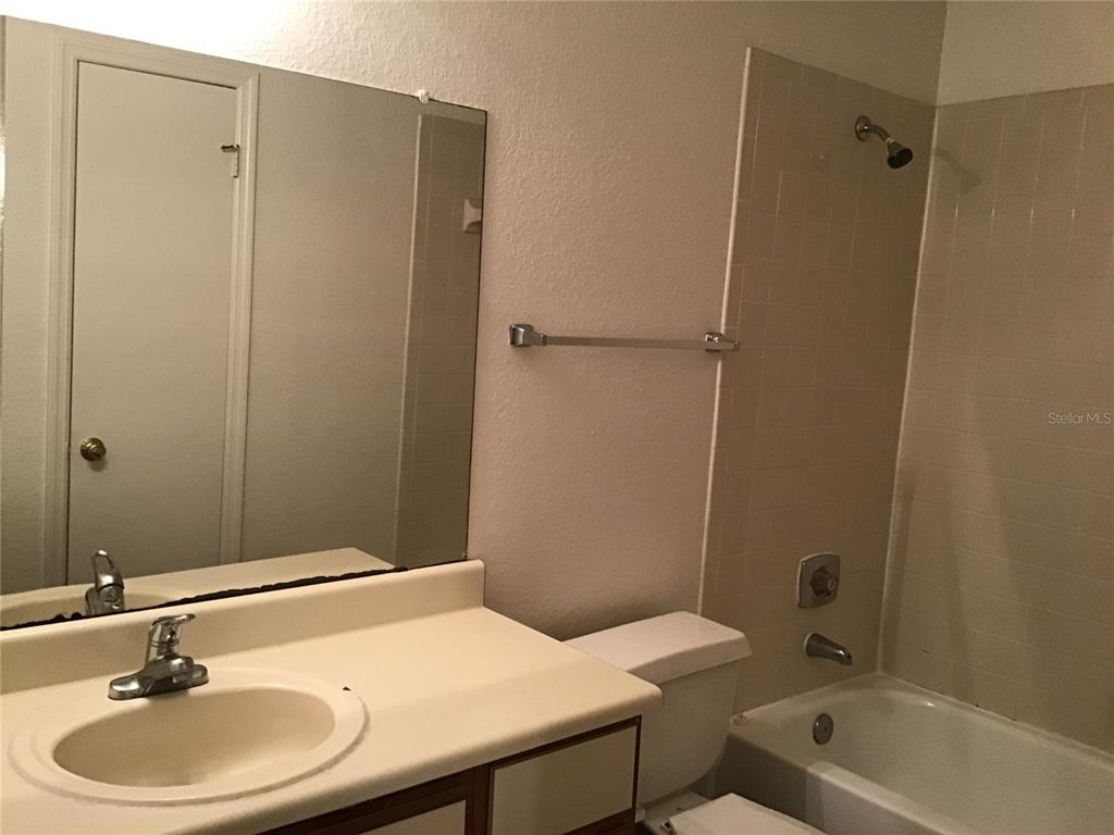 1017 South Hiawassee Road, Unit 3717 Orlando, FL 32835 - Photo 13 of 21 a bathroom with a sink a toilet and shower