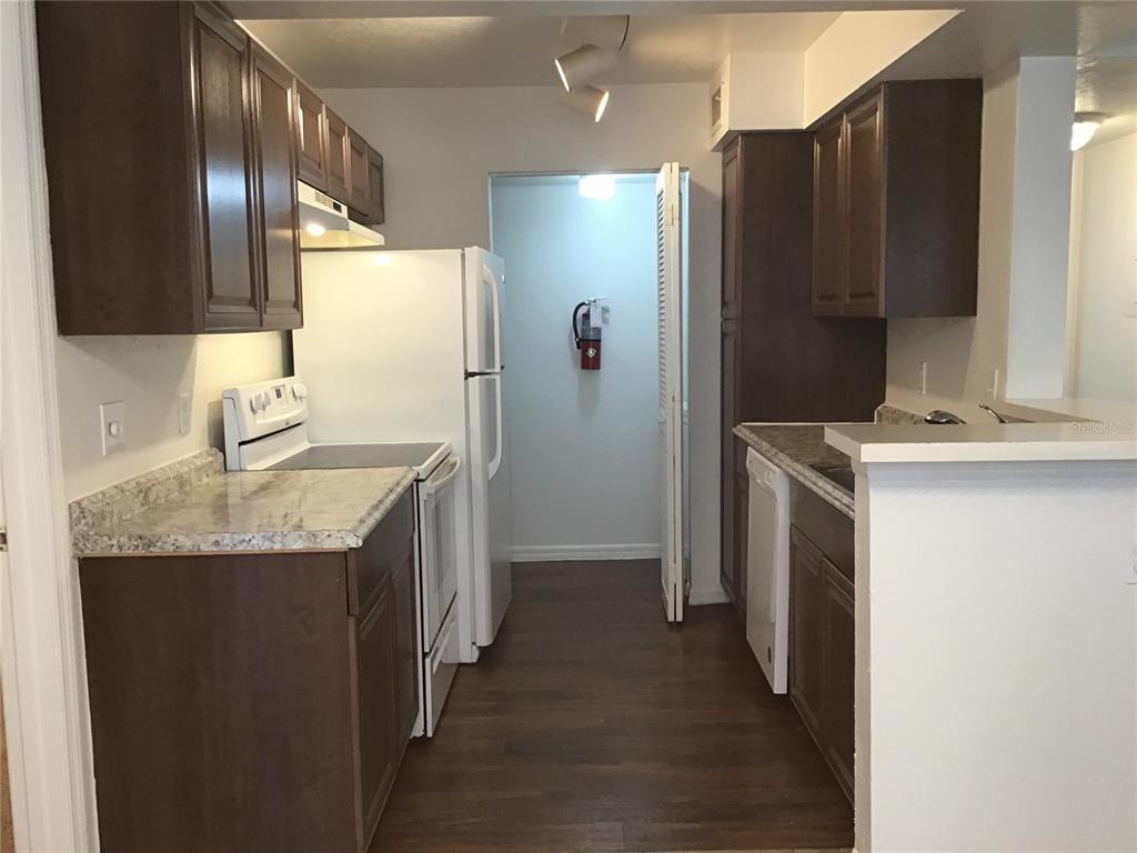1017 South Hiawassee Road, Unit 3717 Orlando, FL 32835 - Photo 5 of 21 a kitchen with stainless steel appliances granite countertop a sink stove and refrigerator