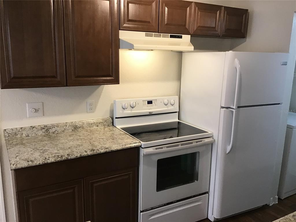 1017 South Hiawassee Road, Unit 3717 Orlando, FL 32835 - Photo 6 of 21 a kitchen with a refrigerator sink and stove