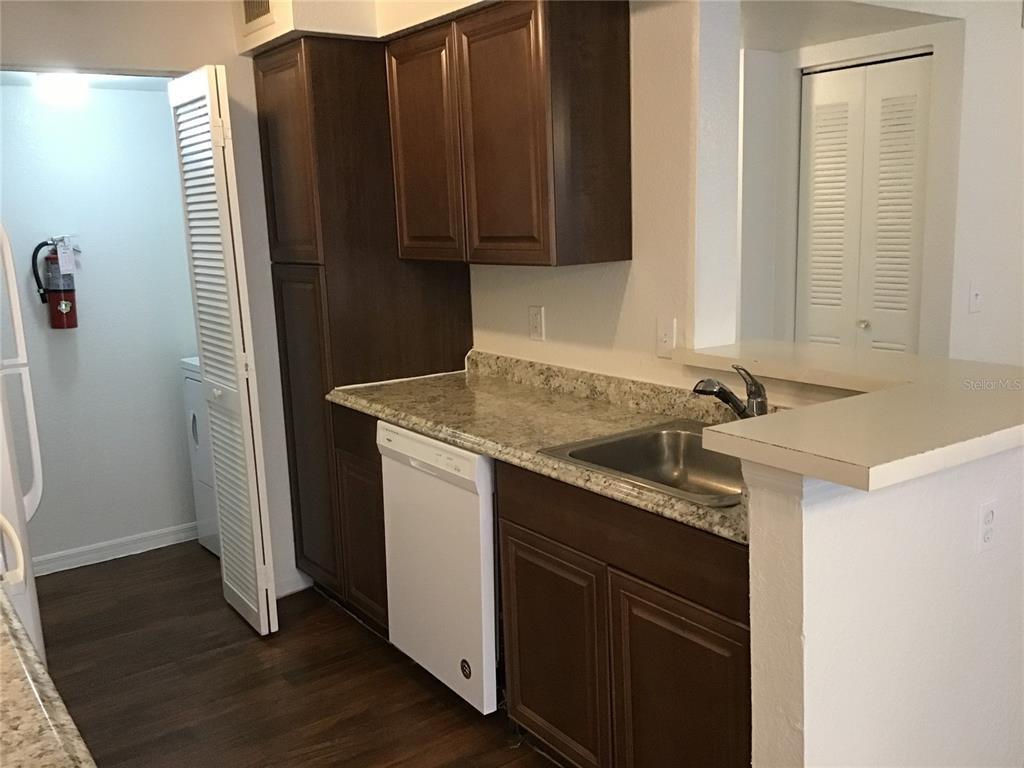1017 South Hiawassee Road, Unit 3717 Orlando, FL 32835 - Photo 7 of 21 a kitchen with a sink and a refrigerator