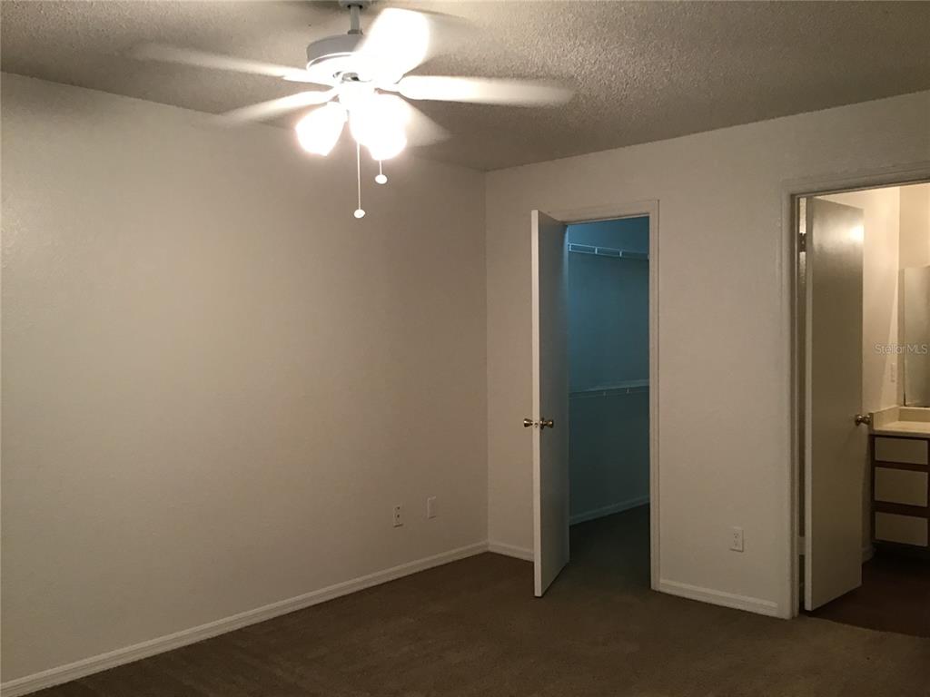 1017 South Hiawassee Road, Unit 3717 Orlando, FL 32835 - Photo 10 of 21 an empty room with a fan & a ceiling fan