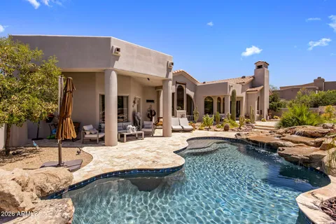 a view of swimming pool and outdoor seating