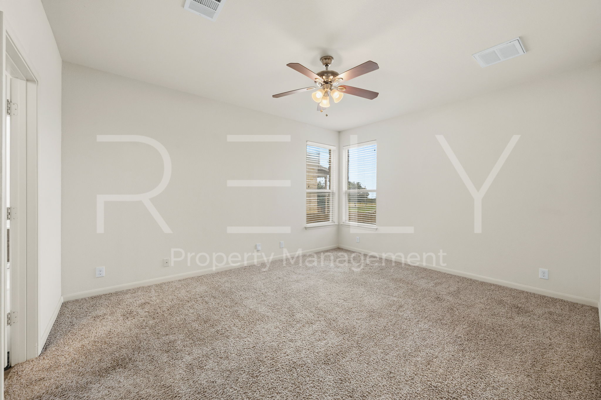 1405 Sunny Meadows Loop Georgetown, TX 78626 - Photo 15 of 40 A quiet retreat with plush carpeting and natural light filtering through corner windows.