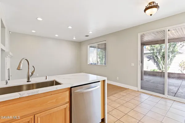 a kitchen with kitchen island a sink appliances and a counter space