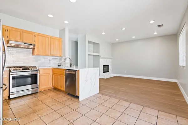 a kitchen with a stove a sink and a refrigerator