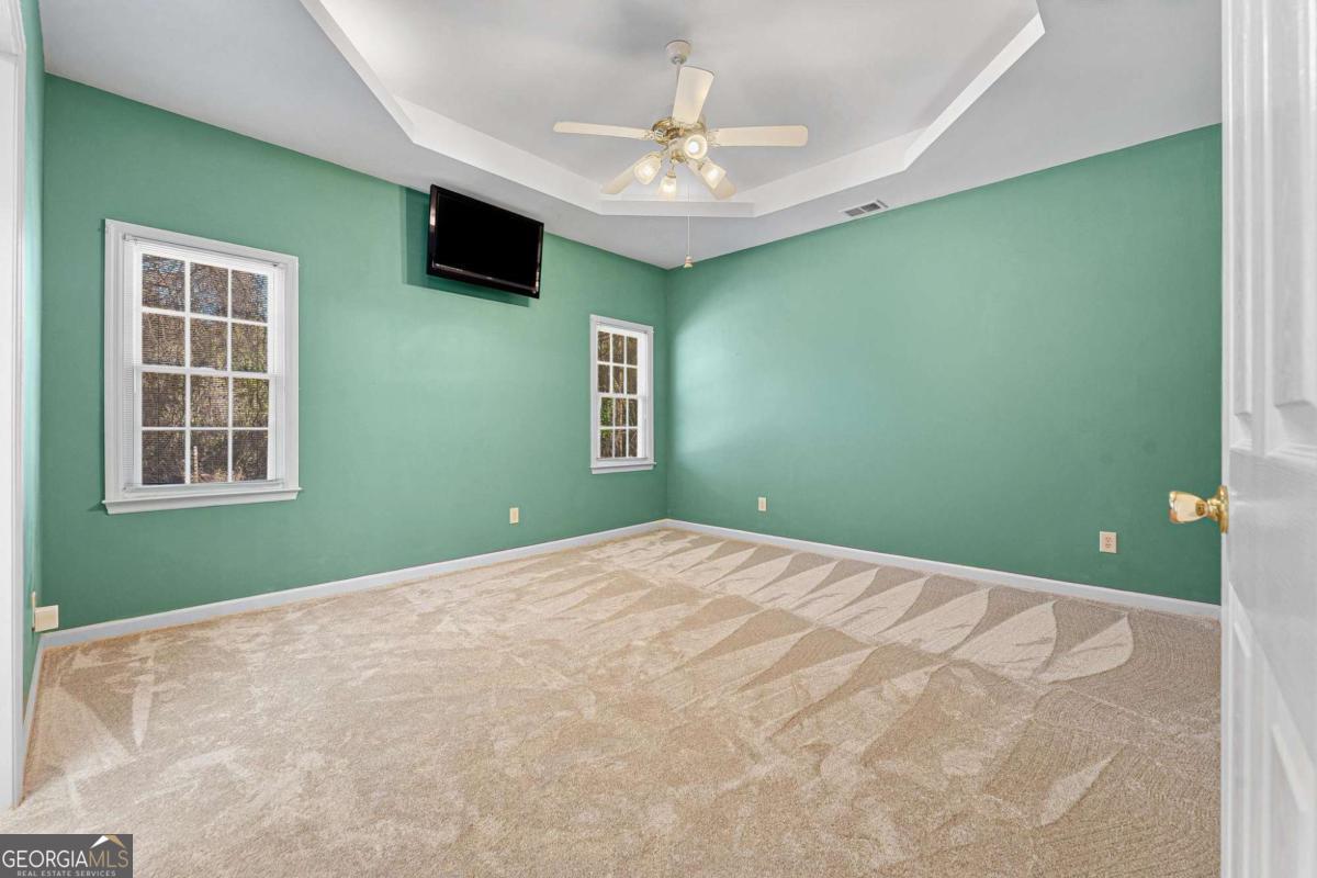 6270 Old Jefferson Road Athens, GA 30607 - Photo 14 of 33 a view of a bedroom with a ceiling fan and a window