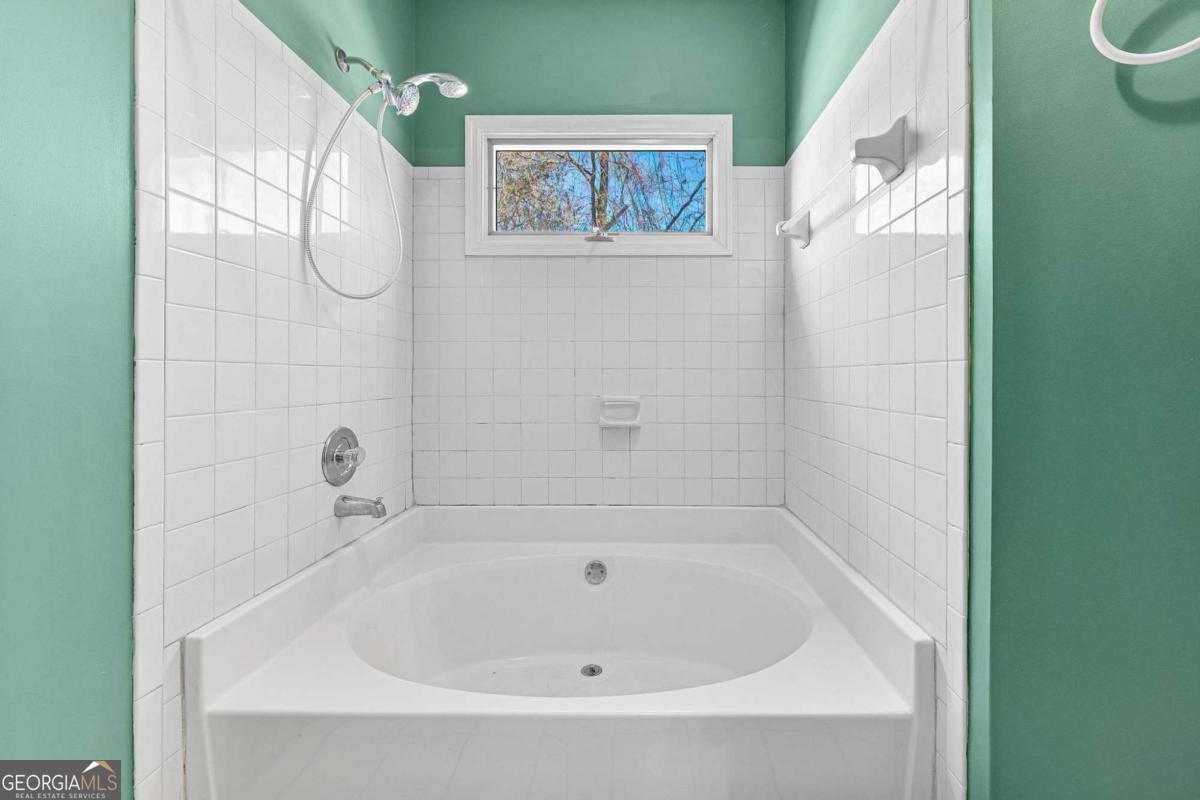 6270 Old Jefferson Road Athens, GA 30607 - Photo 17 of 33 a white bath tub sitting next to a white sink and vanity