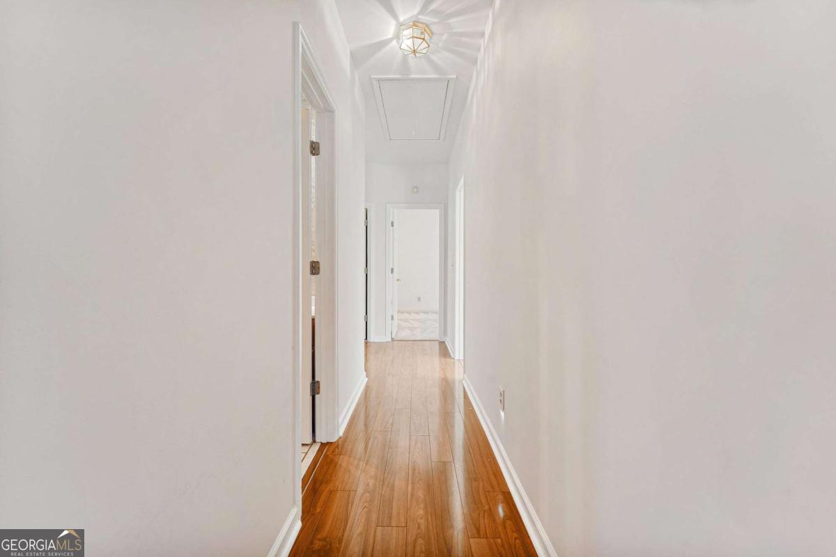 6270 Old Jefferson Road Athens, GA 30607 - Photo 18 of 33 a view of a hallway with wooden floor and a chandelier