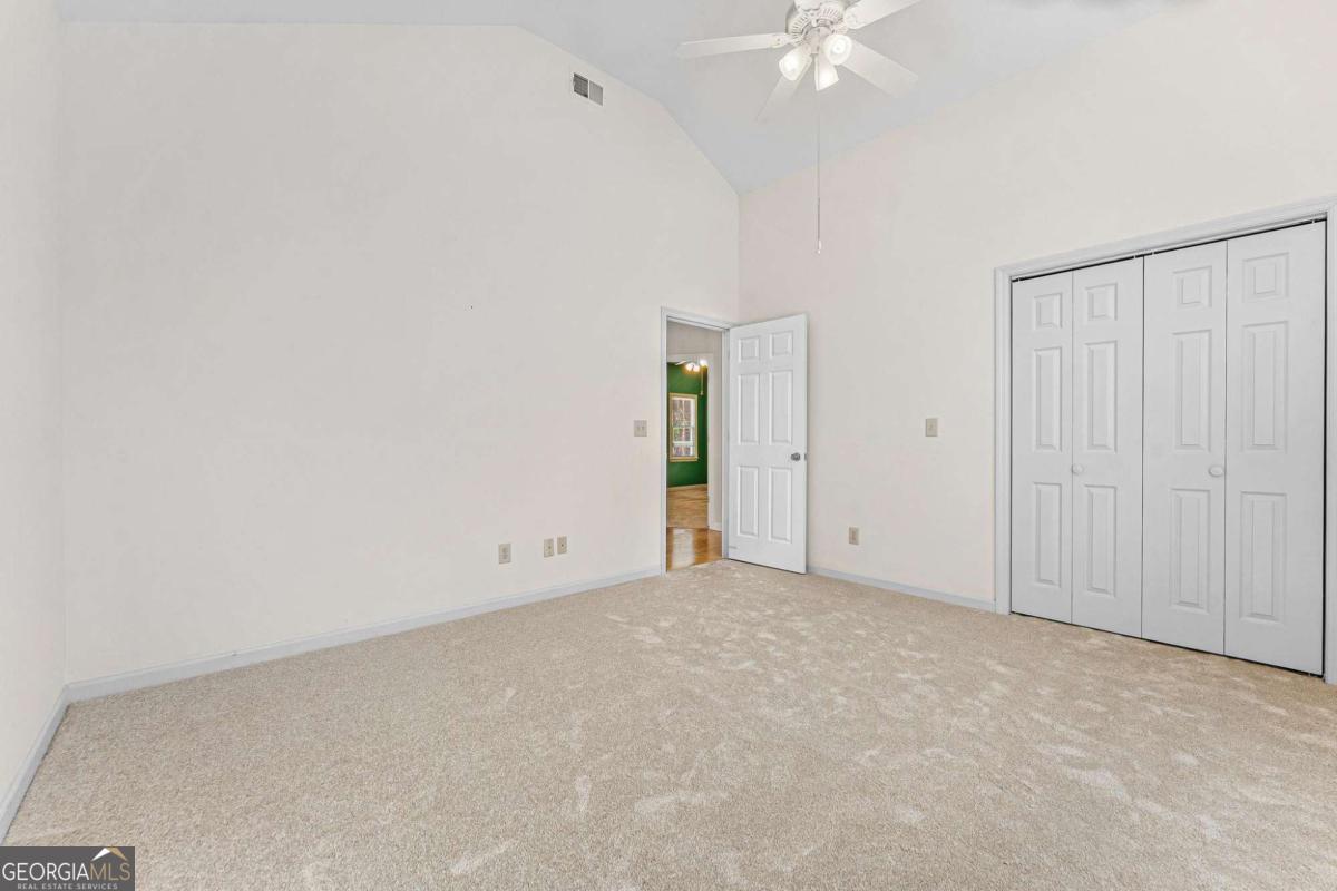 6270 Old Jefferson Road Athens, GA 30607 - Photo 24 of 33 an empty room with a ceiling fan and a window