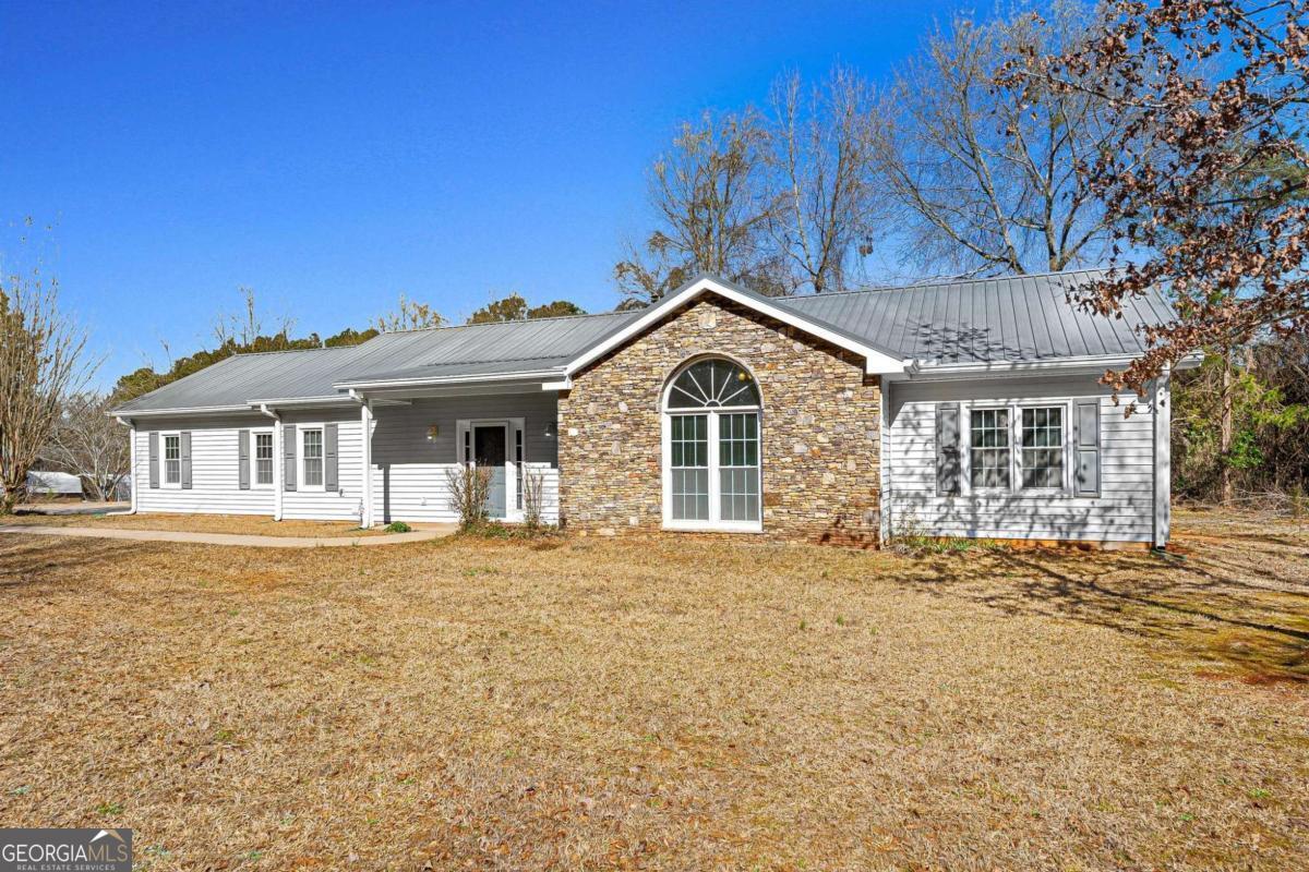 6270 Old Jefferson Road Athens, GA 30607 - Photo 3 of 33 a front view of a house with a garden