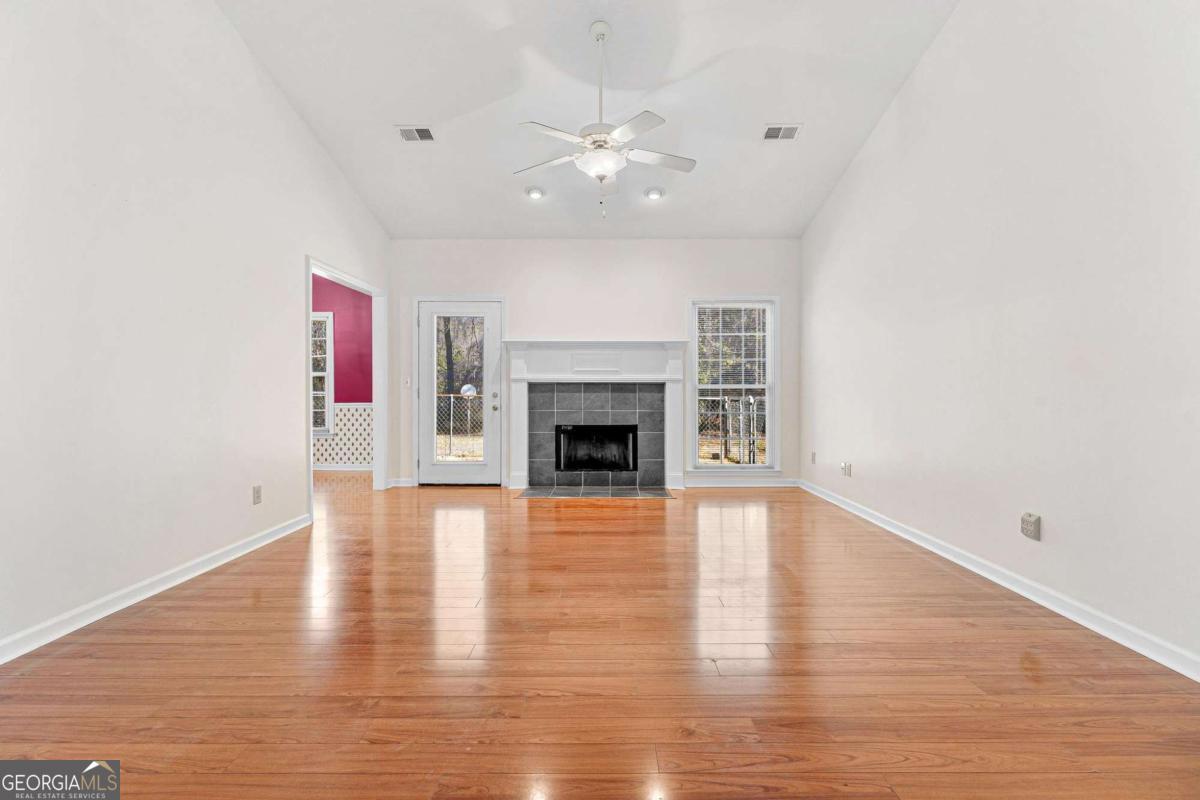 6270 Old Jefferson Road Athens, GA 30607 - Photo 6 of 33 a view of an empty room with wooden floor and fireplace