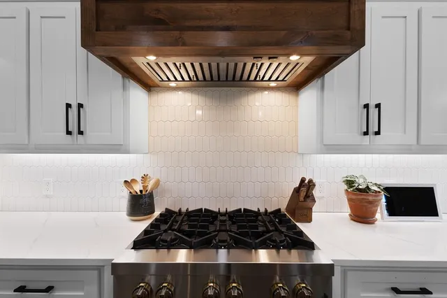 a kitchen with a stove and a cabinets