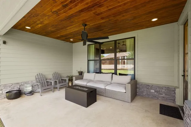 a front view of a house with swimming pool having outdoor seating