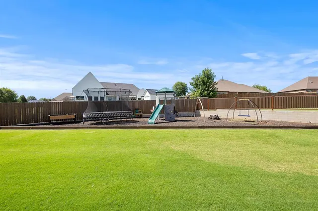 a view of backyard of house with green space