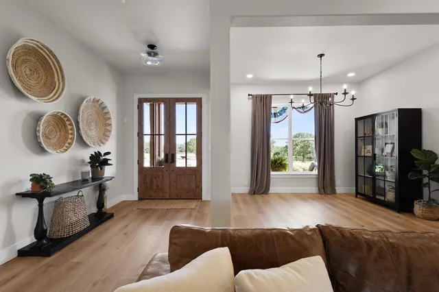 a living room with furniture a window and a chandelier