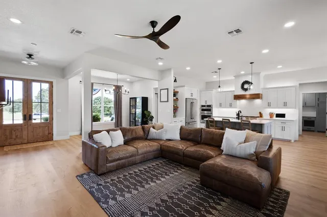a living room with furniture and a large window
