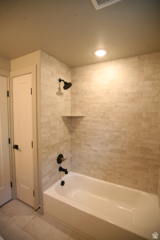 635 East Mountain Road North Ogden, UT 84414 - Photo 13 of 33 Bathtub and shower combination featuring stacked rectangular wall tile and matte black fixtures