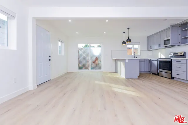 a kitchen with stainless steel appliances granite countertop a sink and a stove