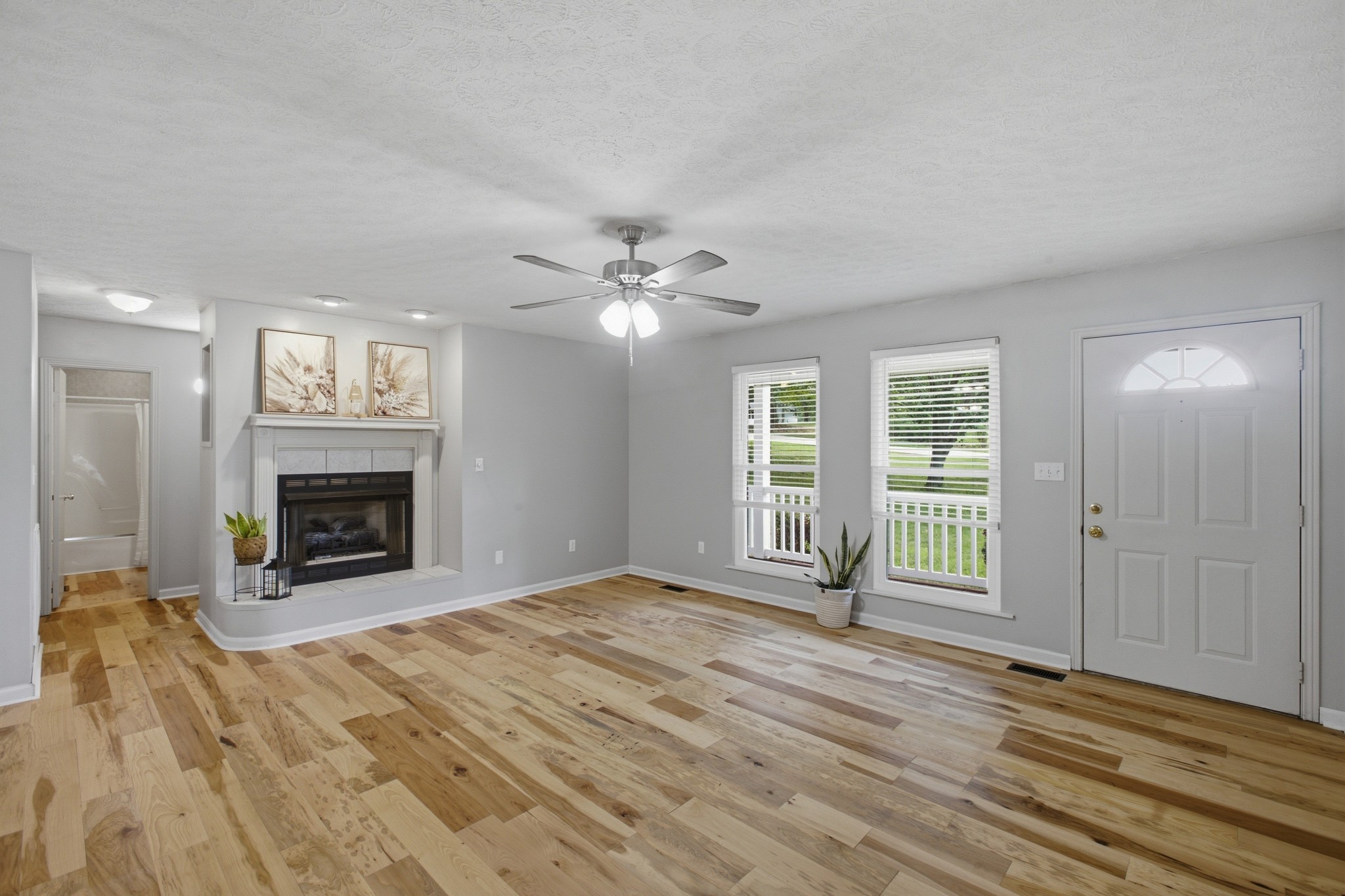 1466 West Grab Creek Road Dickson, TN 37055 - Photo 10 of 30 a view of an empty room with wooden floor fireplace and a window