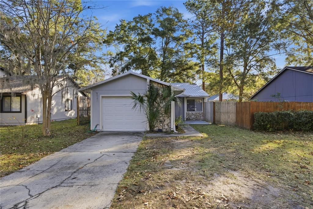 1939 Southwest 73rd Terrace Gainesville, FL 32607 - Photo 1 of 26 a house with trees in the background