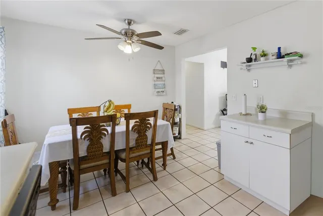 a view of a dining room that has a dining table and chairs