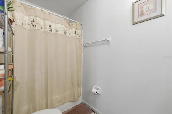 a bedroom with a bed and a flat tv screen on wall