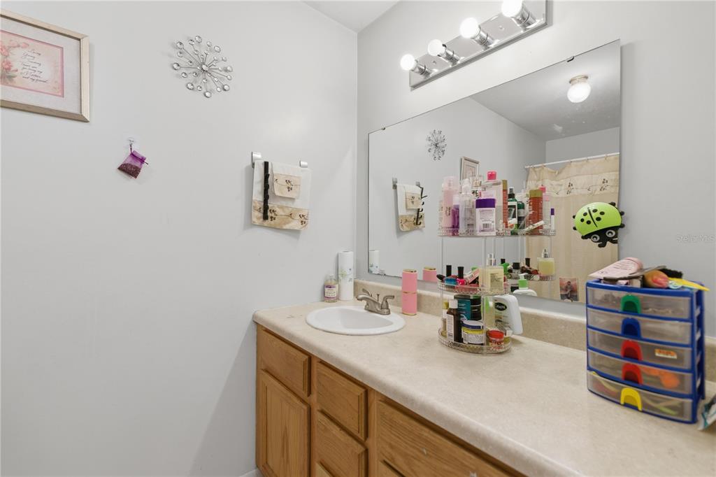 1939 Southwest 73rd Terrace Gainesville, FL 32607 - Photo 17 of 26 a bathroom with a sink and a mirror
