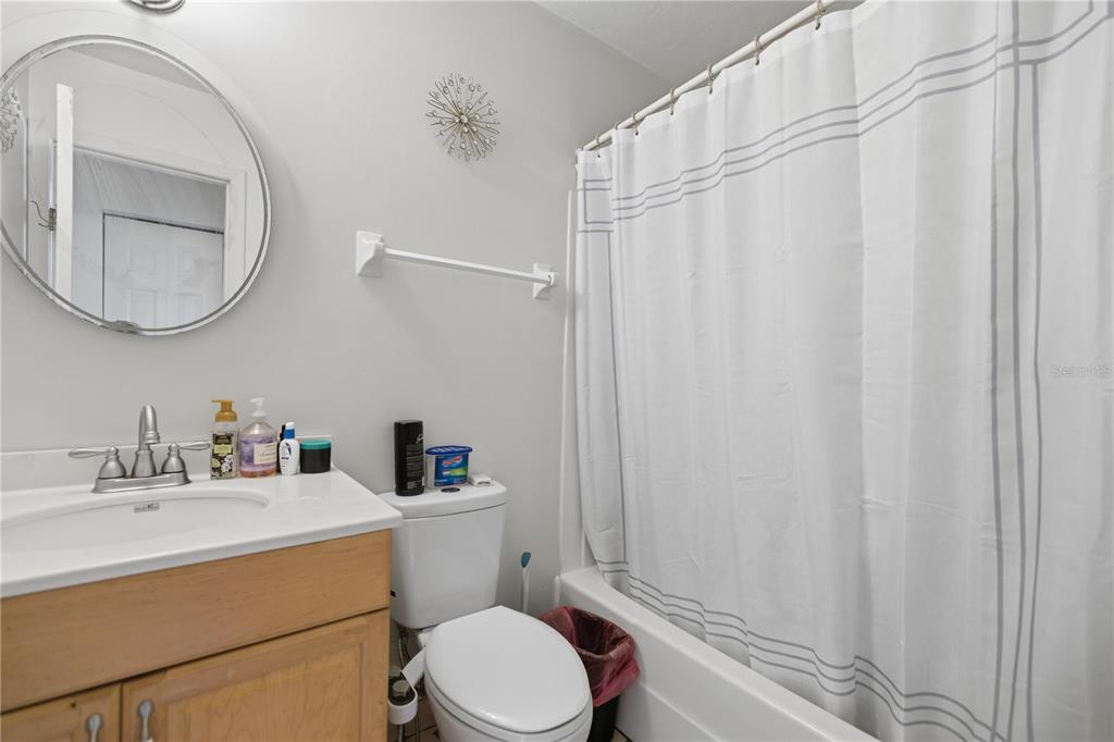 1939 Southwest 73rd Terrace Gainesville, FL 32607 - Photo 18 of 26 a bathroom with a sink a toilet and a mirror