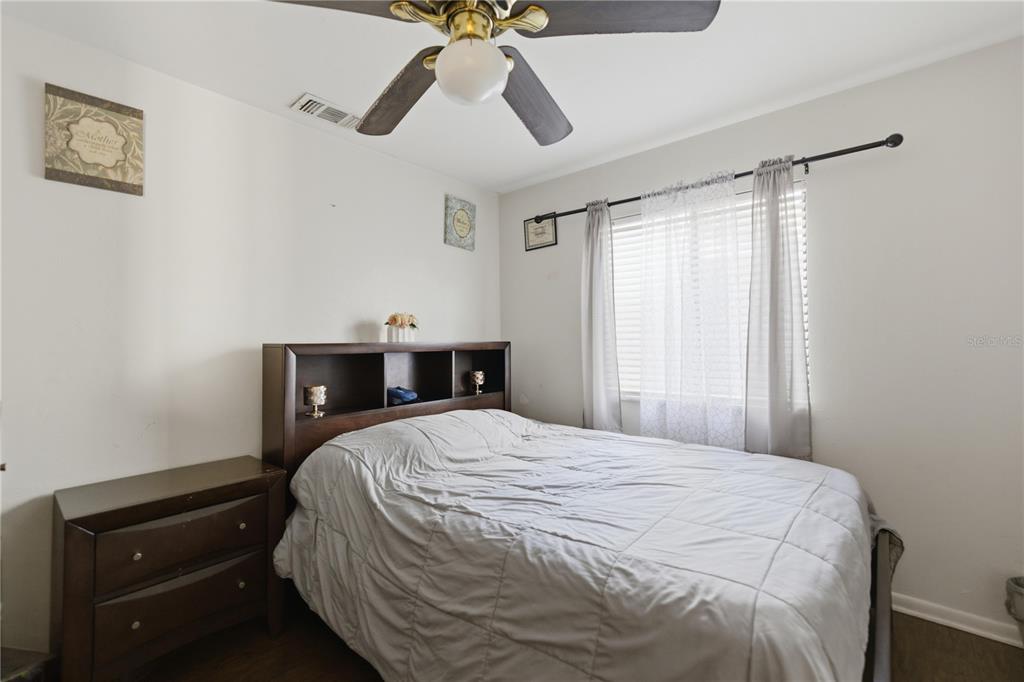 1939 Southwest 73rd Terrace Gainesville, FL 32607 - Photo 19 of 26 a bedroom with a bed and a chandelier