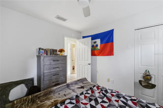 a bedroom with a bed and a window