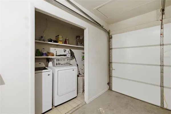 an aerial view of residential house with outdoor space and trees all around