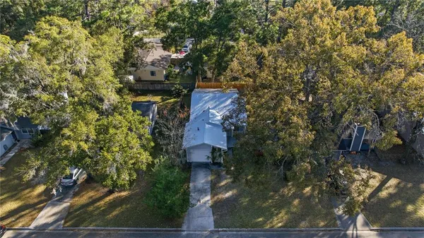 an aerial view of a house with a yard basket ball court and outdoor seating